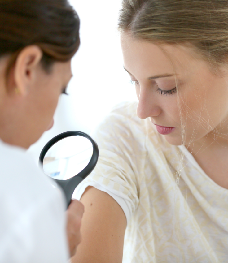 Nurse looking at the skin of a patient