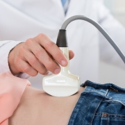 Doctor Moving Ultrasound Probe On Pregnant Woman's Stomach